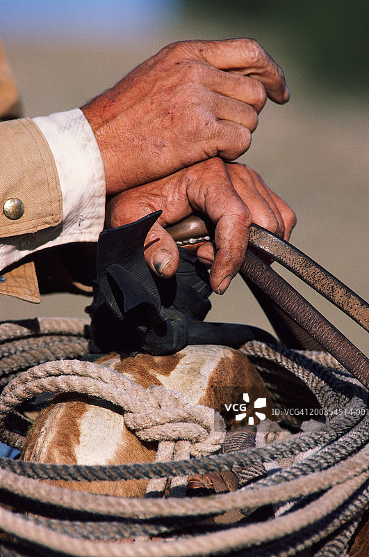 牧场工人手扶马鞍的特写图片素材