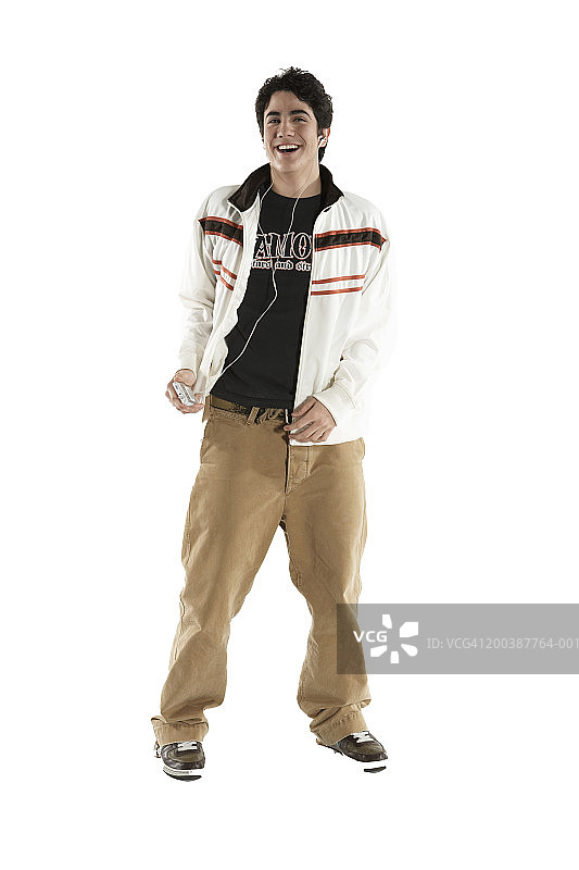 听MP3播放器，微笑的青少年男孩图片素材