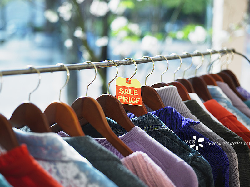 零售店服装架上的衬衫（聚焦促销价标签）图片素材