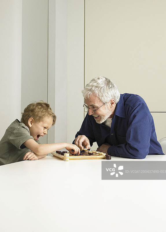 和祖父下跳棋的男孩（5-7岁）图片素材