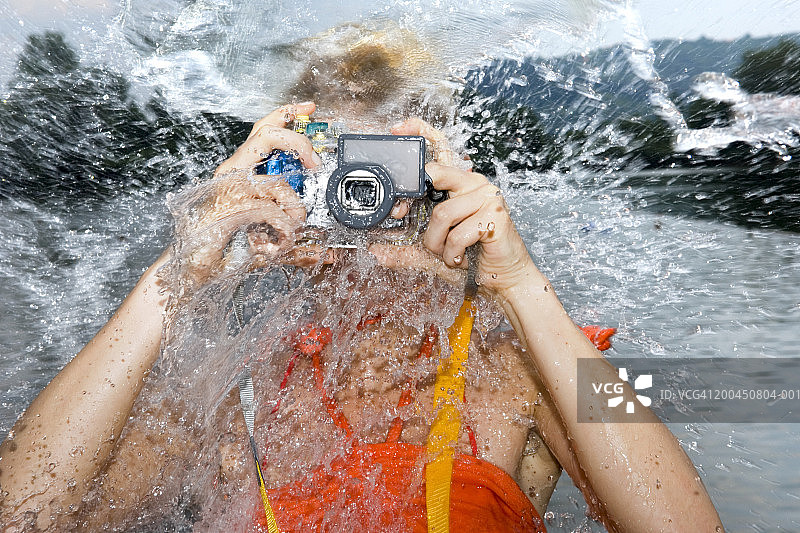 用水下相机拍照的女人被水花溅起图片素材