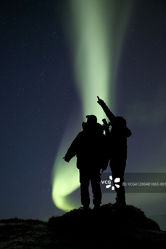观看北极光的两个男人剪影（数字合成）图片素材