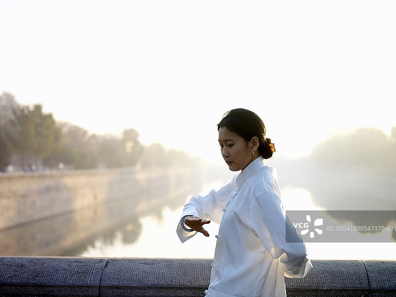 中国女人在故宫湖边练习太极拳图片素材