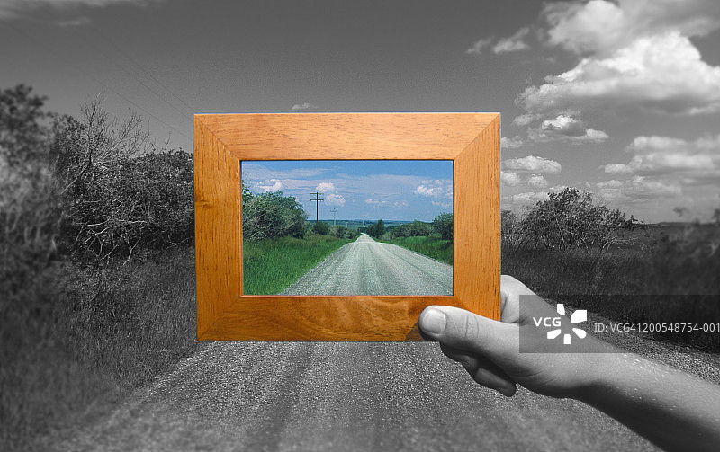 加拿大艾伯塔省，男子在路上举着相框特写图片素材