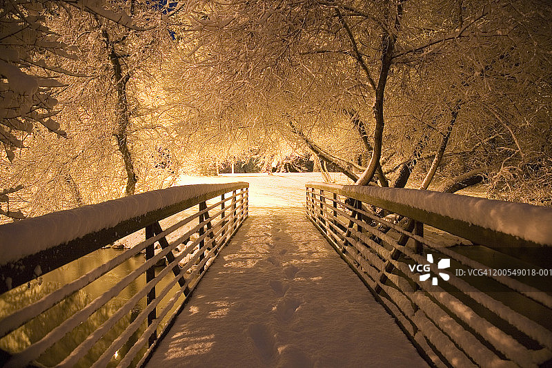 夜间雪地人行桥上的新鲜脚印图片素材