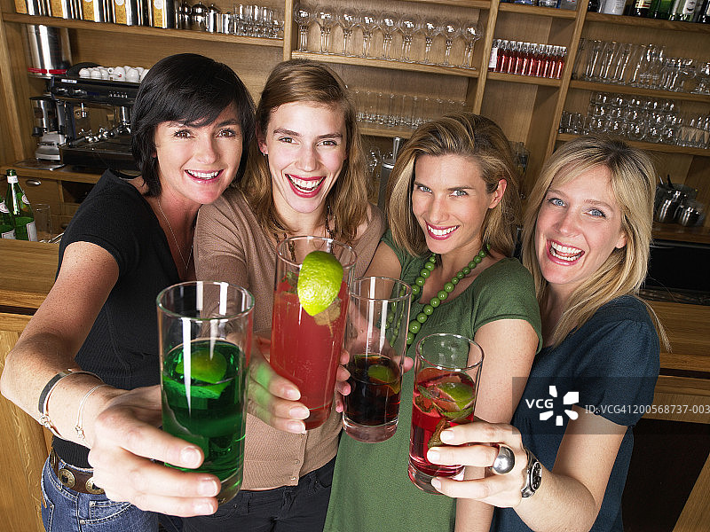 四个女人站在酒吧，微笑，肖像，高角度视图图片素材