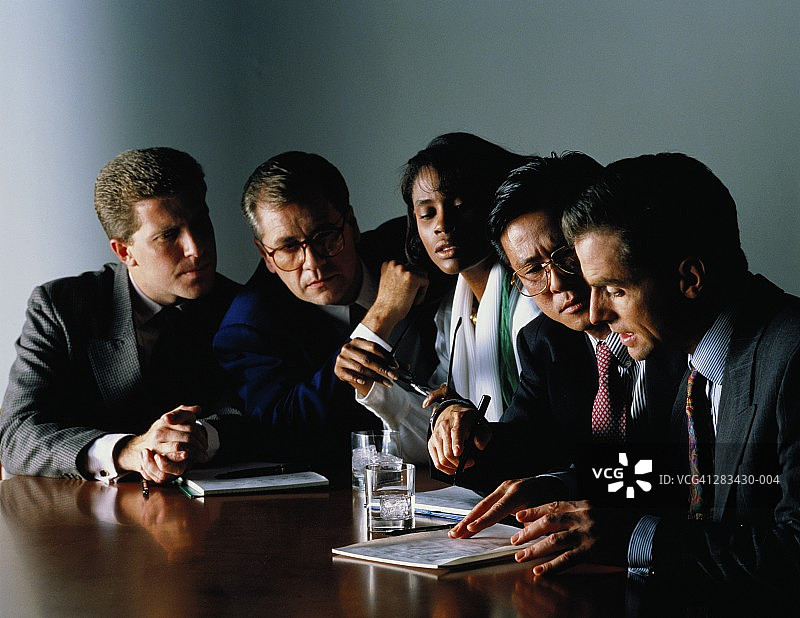 一位女性和四位男性高管在圆桌会议上讨论图片素材