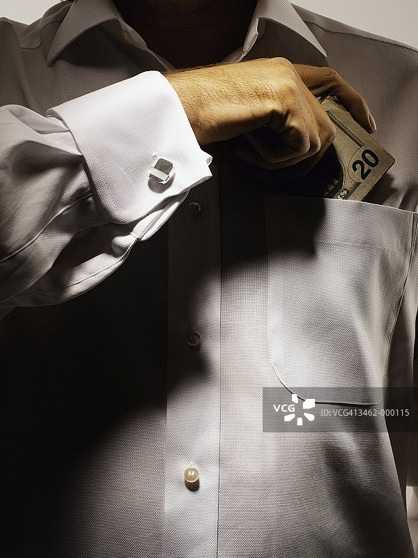 男人把美元放进口袋图片素材