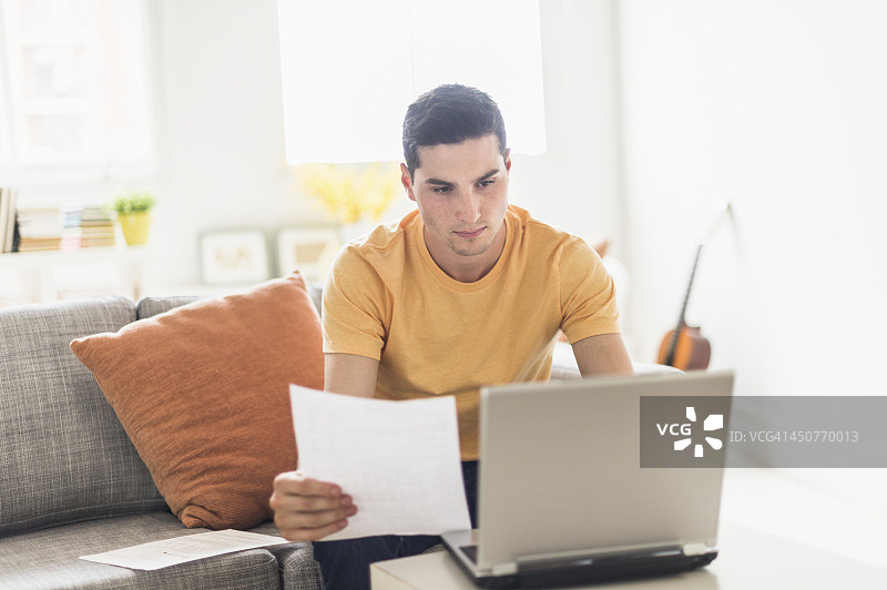 男人在家里用笔记本电脑图片素材