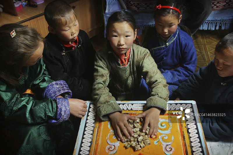 蒙古族儿童在蒙古包里玩沙嘎图片素材