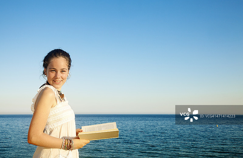 女孩在海边阅读图片素材
