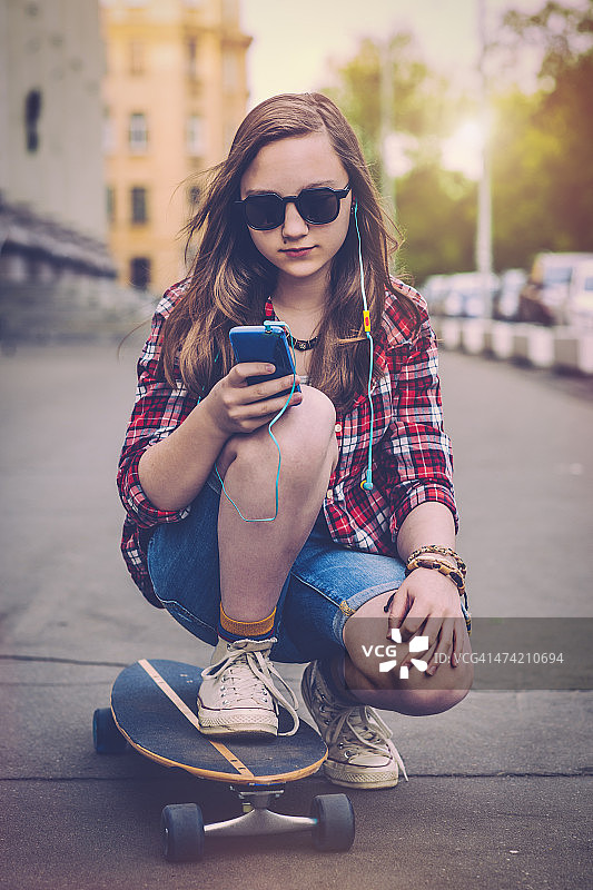 手持滑板的青少年女孩图片素材