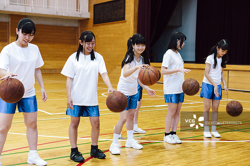 日本高中体育馆内女子篮球队训练场景图片素材