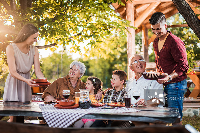 快乐的大家庭在户外共进午餐图片素材