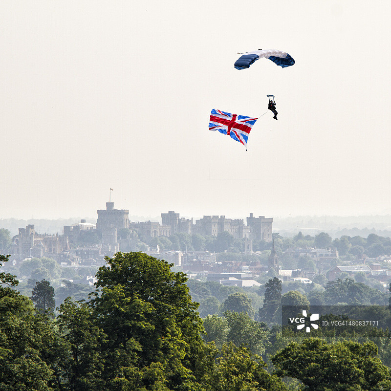 男人在英国温莎城堡上空跳伞图片素材