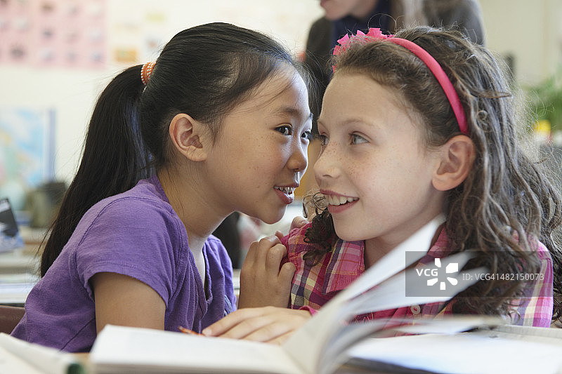 课堂上窃窃私语的学生图片素材