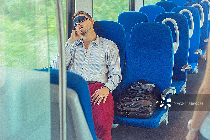 通勤火车上睡觉的年轻男人图片素材