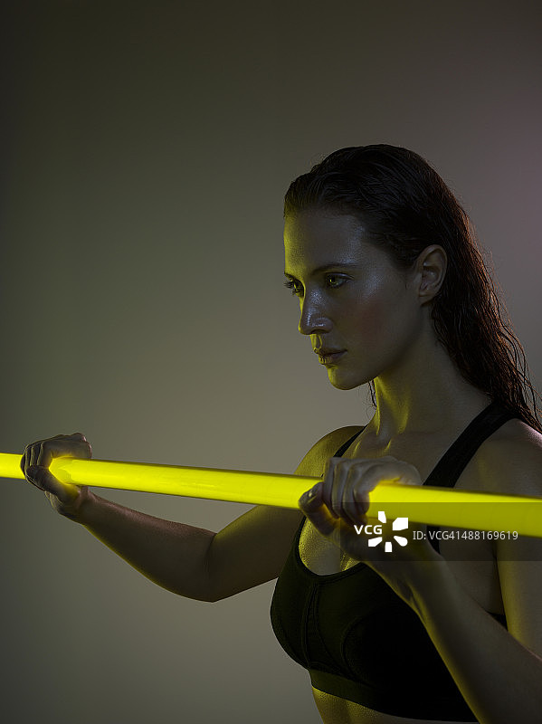 女人拿着霓虹灯棒锻炼图片素材