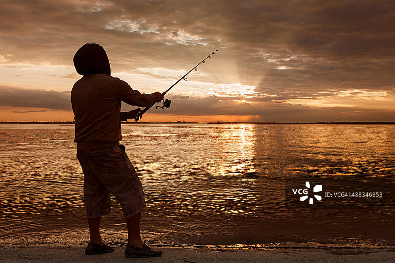 日落时渔夫的剪影图片素材