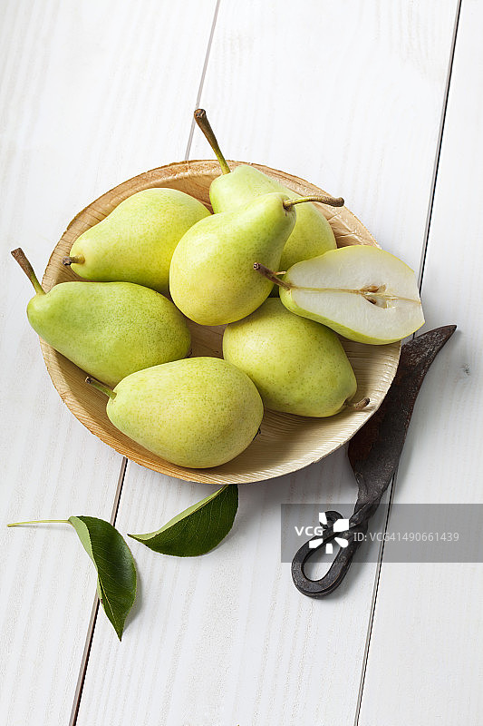 棕榈叶盘装梨子与刀具图片素材