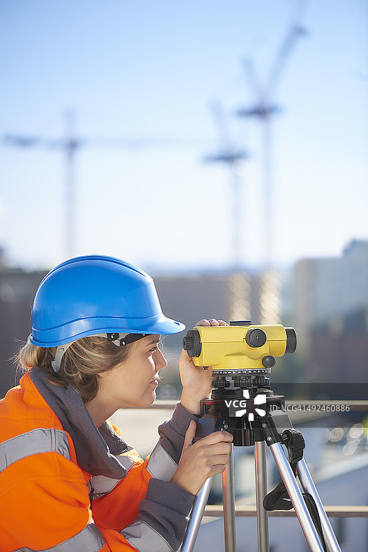 屋顶上的建筑工地女测量员图片素材