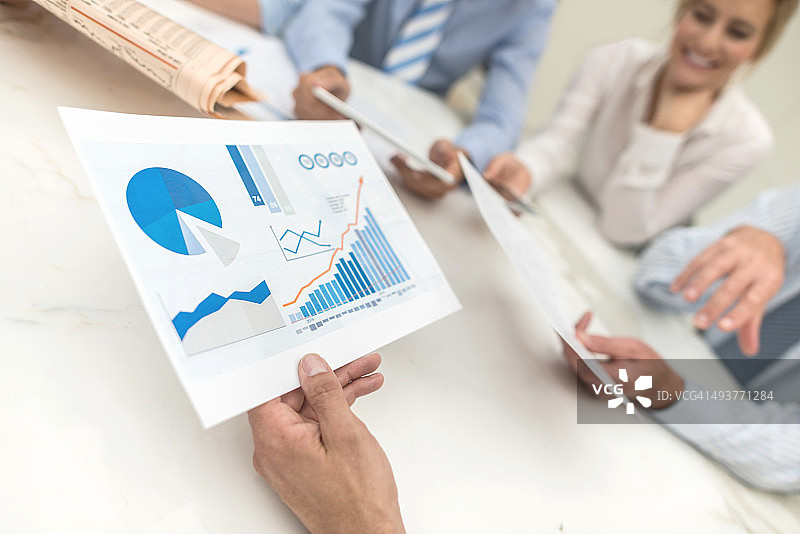 在商务会议中查看市场行为的人们图片素材