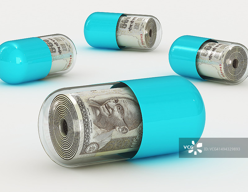 药丸中的钱，象征医疗费用图片素材