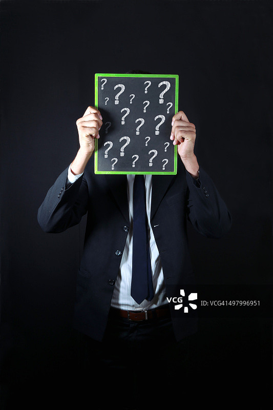 拿着大问号的商人图片素材