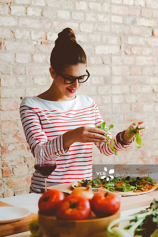 女人在现代厨房里准备披萨图片素材