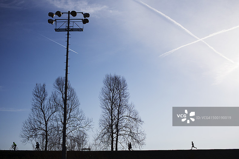 晨曦蓝天下的慢跑者剪影图片素材