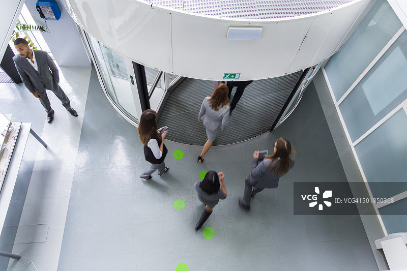 一群上班族通过旋转门进入图片素材