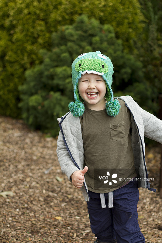 戴着绿帽子微笑的男孩图片素材