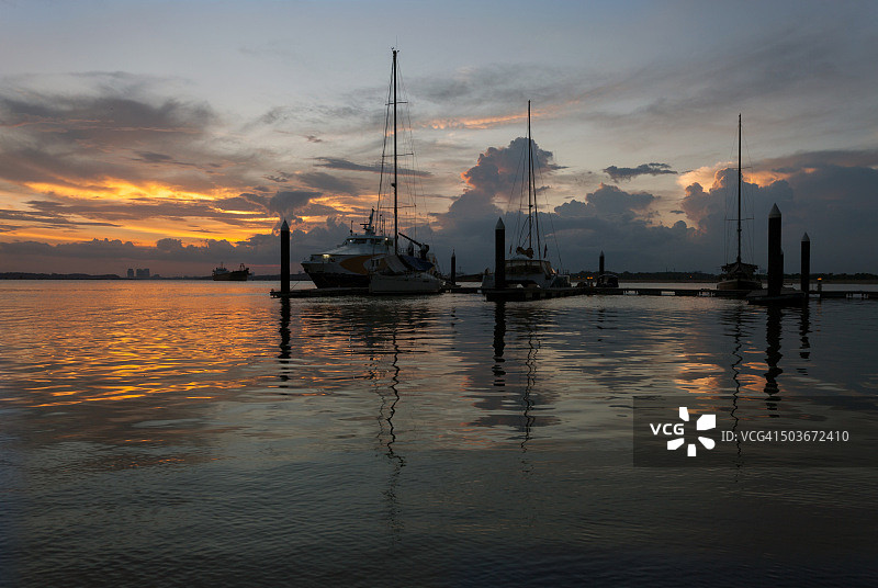 停靠在壮丽日落下的游艇图片素材