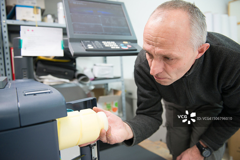 男人更换黄色墨粉盒图片素材