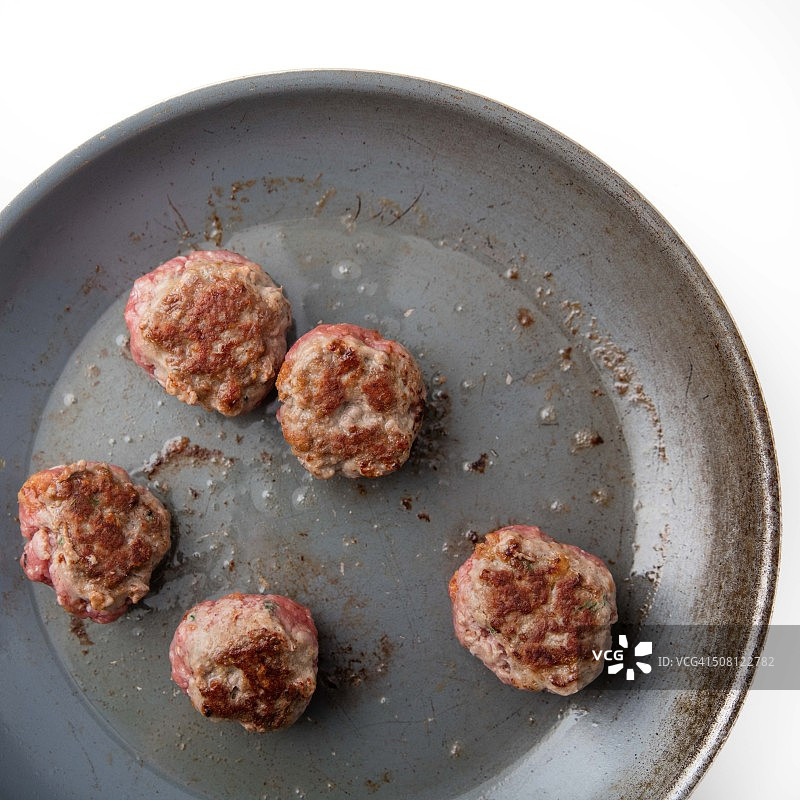 在平底锅中烤肉丸。图片素材