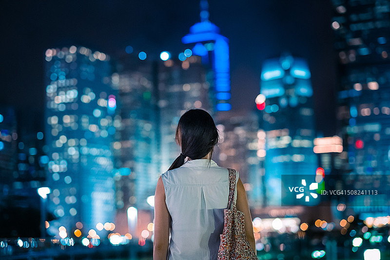 眺望壮丽城市景观的年轻女子图片素材