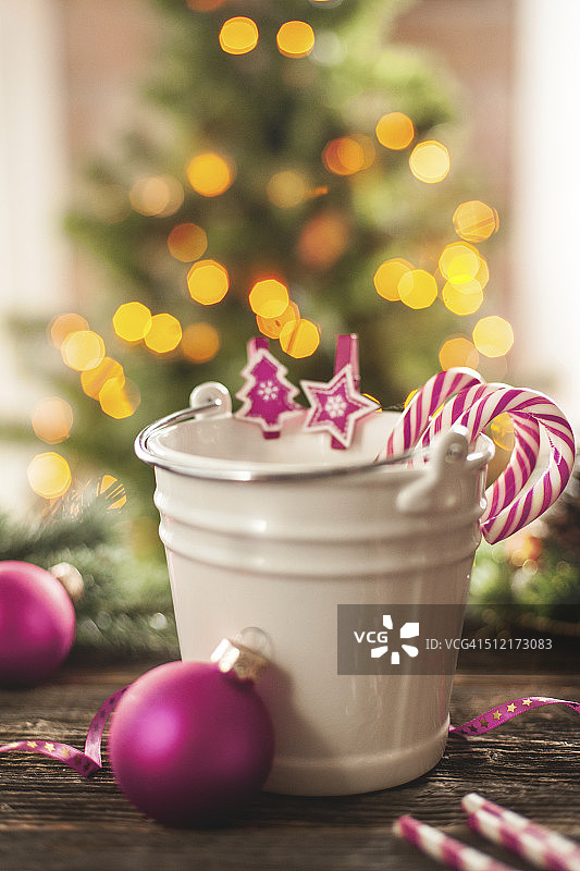 木桌上的白色小桶里的拐杖糖图片素材
