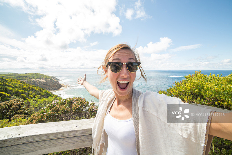 快乐的年轻女人在海岸线自拍图片素材