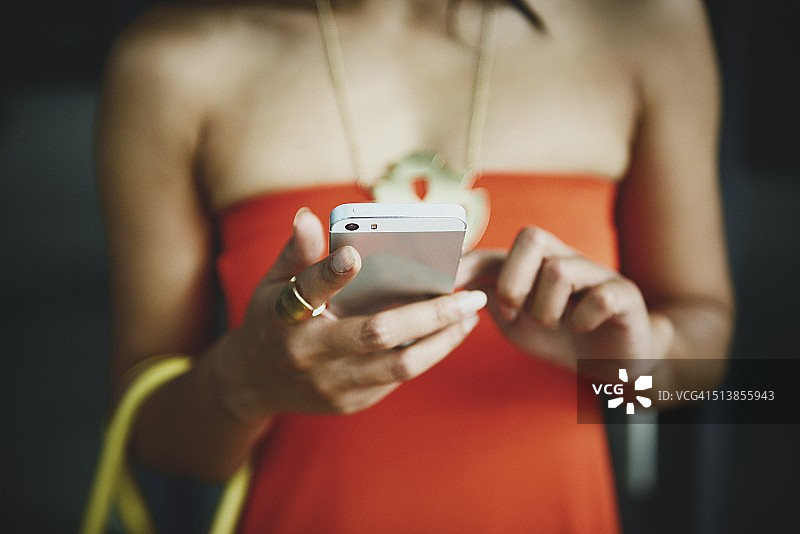 穿着考究的女人在查看智能手机图片素材