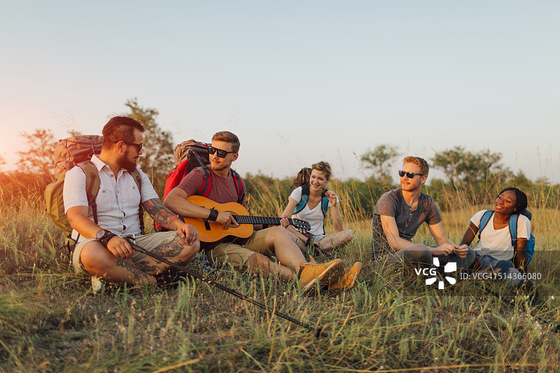 朋友们在徒步时弹吉他图片素材
