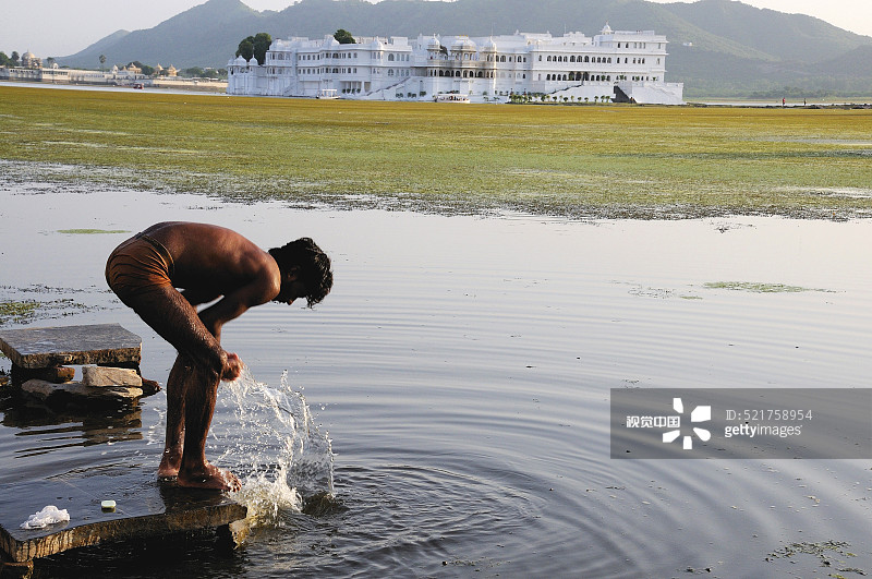 男子在印度拉贾斯坦邦乌代浦皮丘拉湖中沐浴图片素材