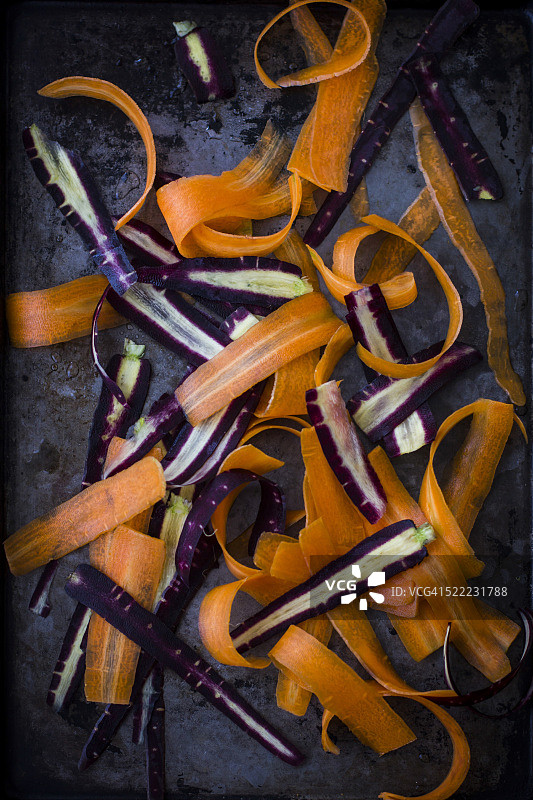 深色托盘上的紫色和橙色胡萝卜丝图片素材