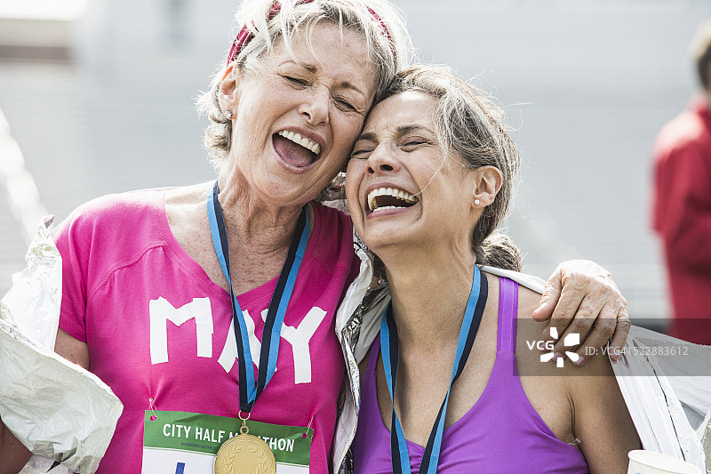 女性参加公路赛，佩戴奖牌并庆祝胜利图片素材