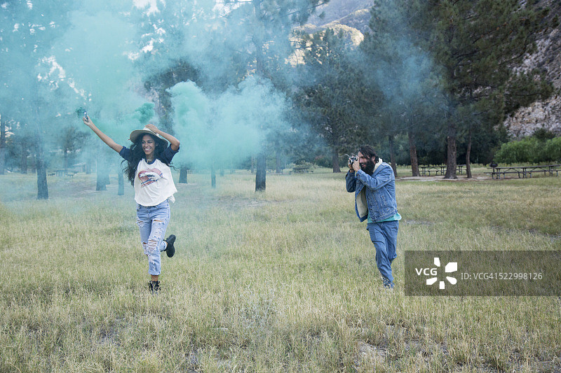 男人拍摄手持烟雾棒的女人图片素材
