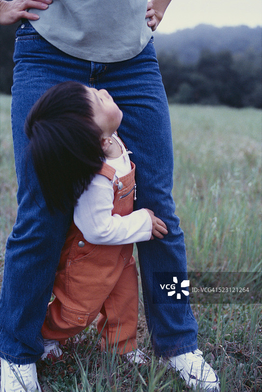 幼儿站在母亲两腿之间图片素材