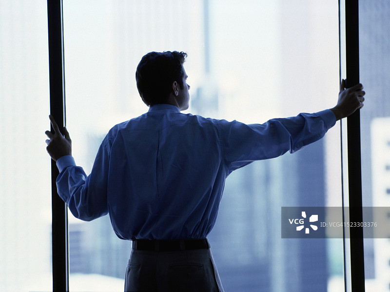站在窗户旁的商人图片素材
