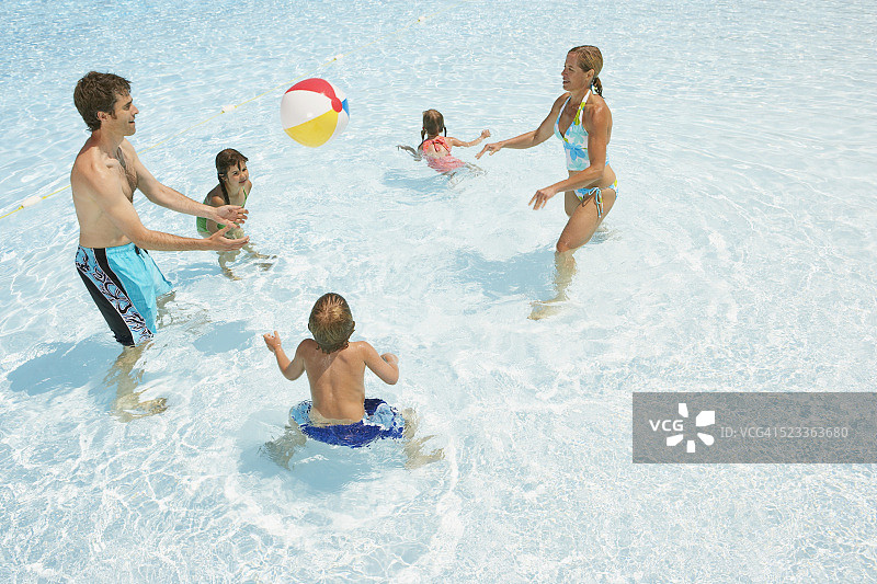 在游泳池浅水区玩耍的家庭图片素材