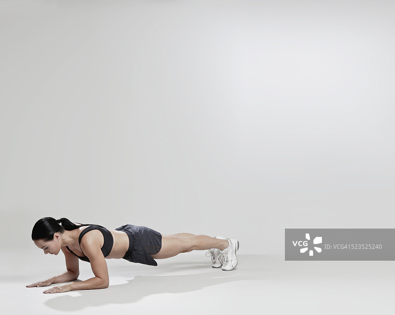 女人保持着平板支撑的姿势图片素材