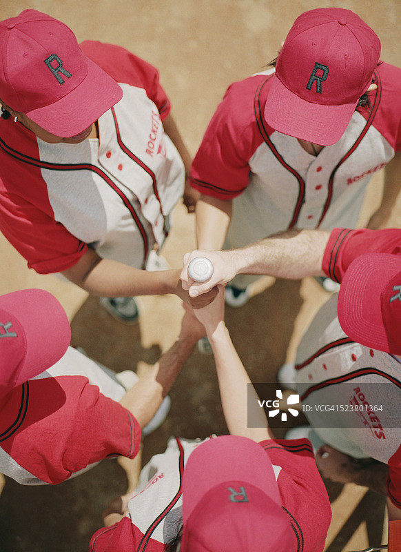 垒球运动员围成一圈拿着球棒图片素材