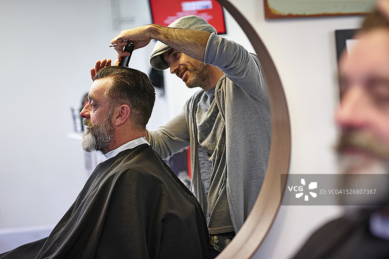 在理发椅上理发的男人图片素材